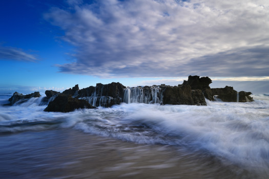 Echoes of the Ocean: Mesmerizing Acrylic Print of the Lively Dance Between Waves and Rocks at Dawn