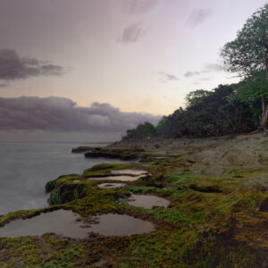 Mystical Seaside: Enchanting Acrylic Print of Mossy Rocks and a Sunset Shrouded in Sea Mist