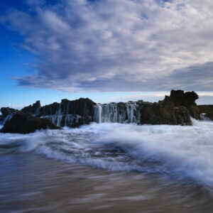 Echoes of the Ocean: Mesmerizing Acrylic Print of the Lively Dance Between Waves and Rocks at Dawn