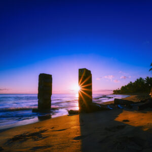 Rising into the Mystical: Tropical Beach Sunrise Illuminates the Ocean Surface and the Mysterious Pillars That Rise from Below, in this Acrylic Print